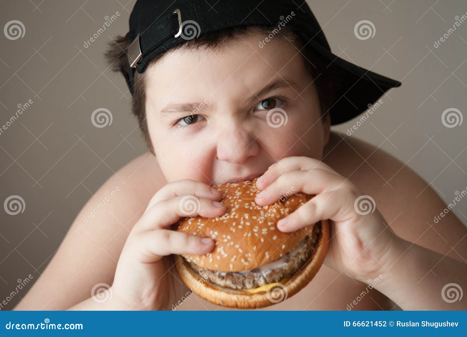 Boy eating burger stock photo. Image of mouth, cheeseburger 66621452
