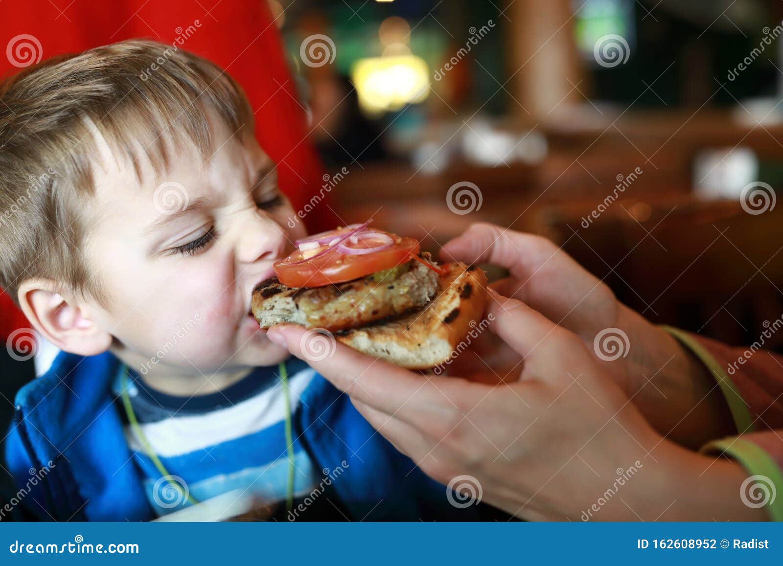 Boy eating burger stock photo. Image of food, male, childhood 162608952