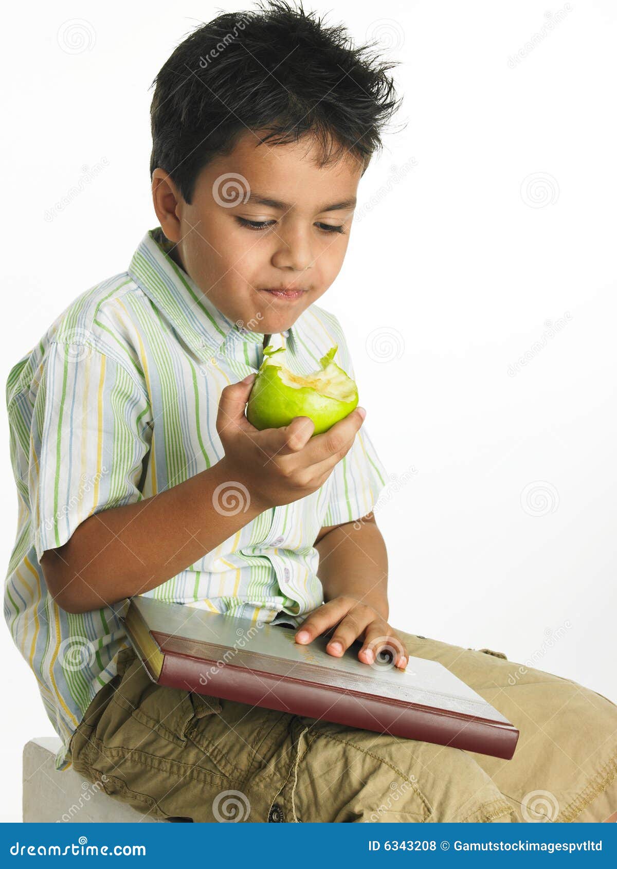Boy eating a green apple stock photo. Image of apple, bitting 6343208