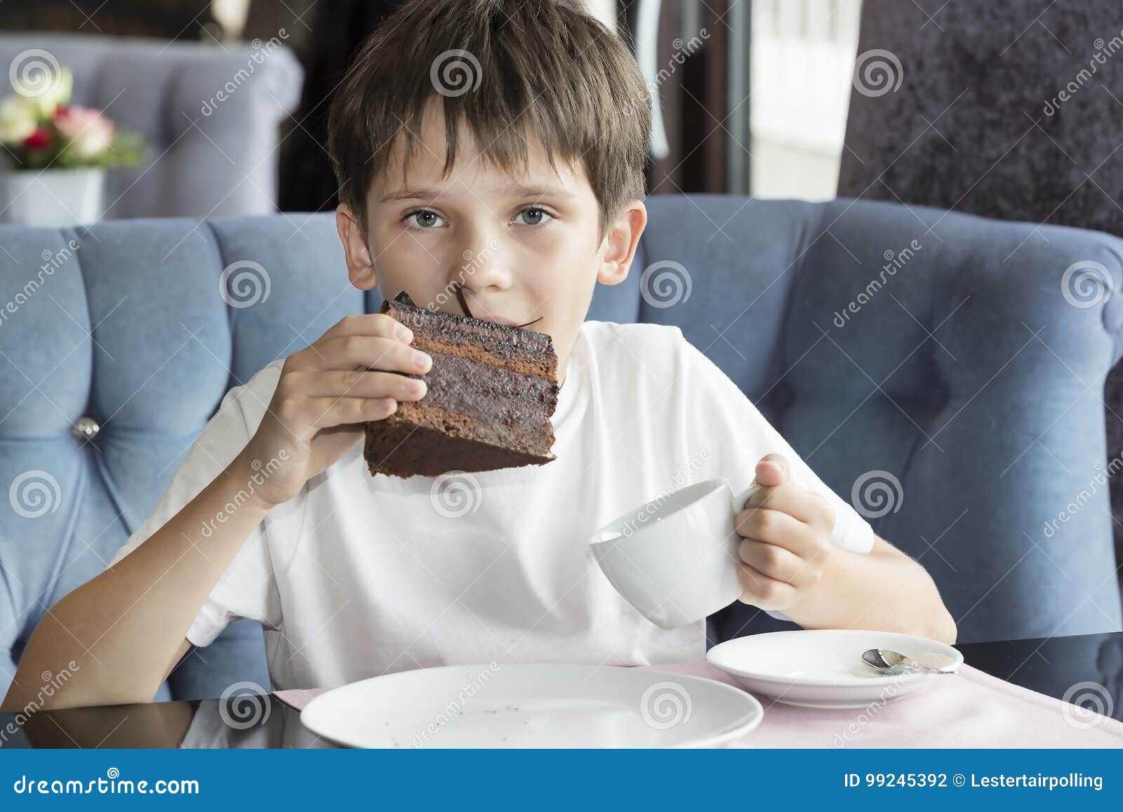 The Boy is Eating a Large Piece of Cake Stock Photo Image of
