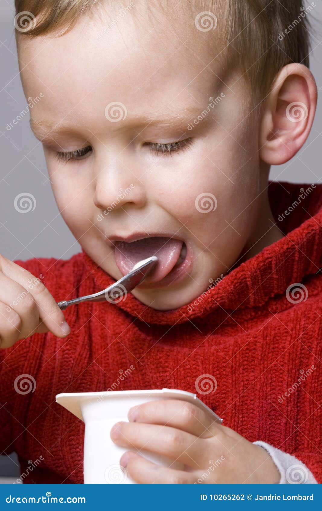 Boy eating yogurt stock photo. Image of happy, cute, children 10265262