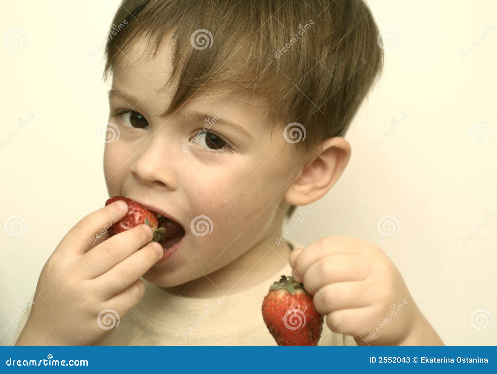 The boy eats berries stock image. Image of appetite, childhood 2552043