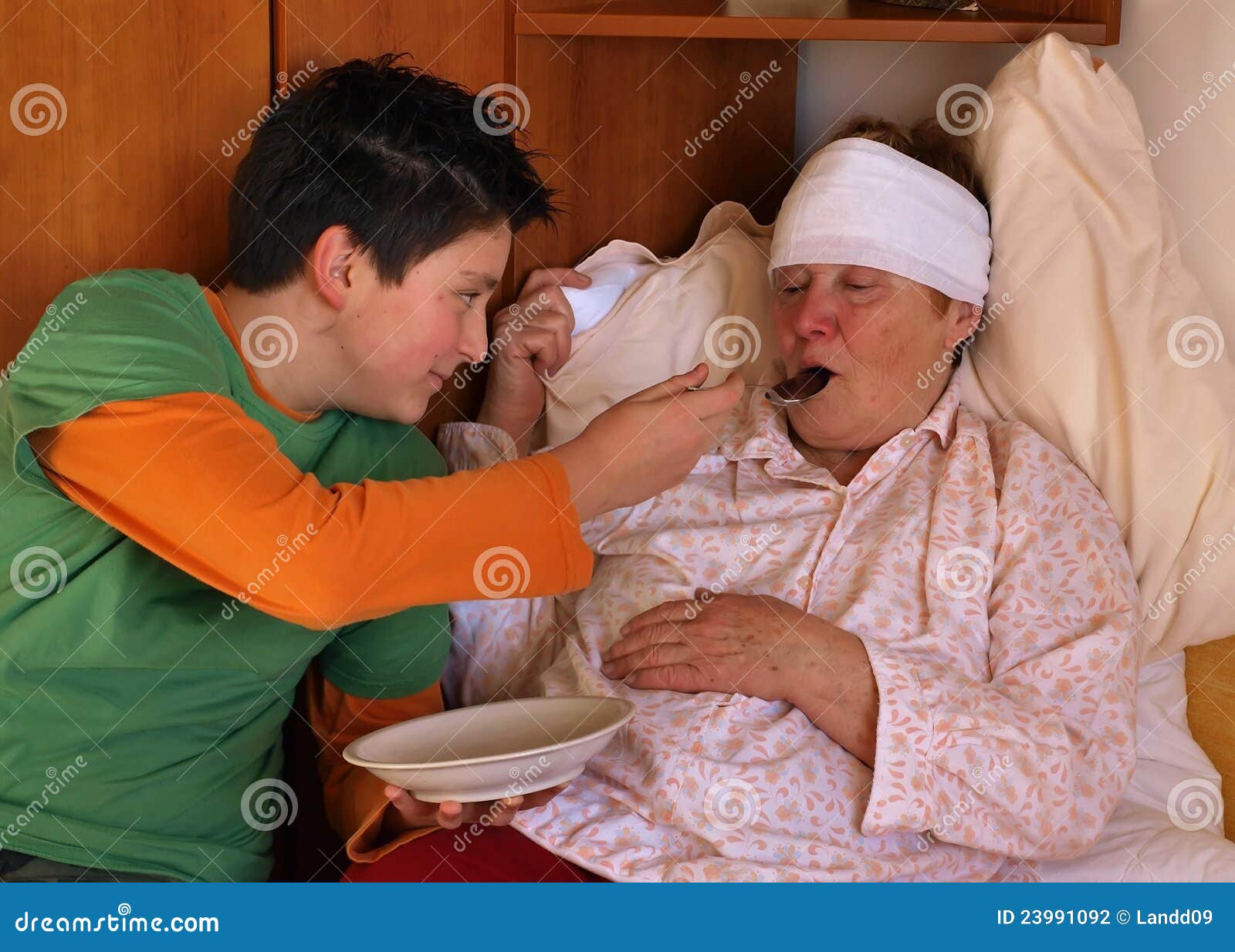 the boy feeds the sick woman