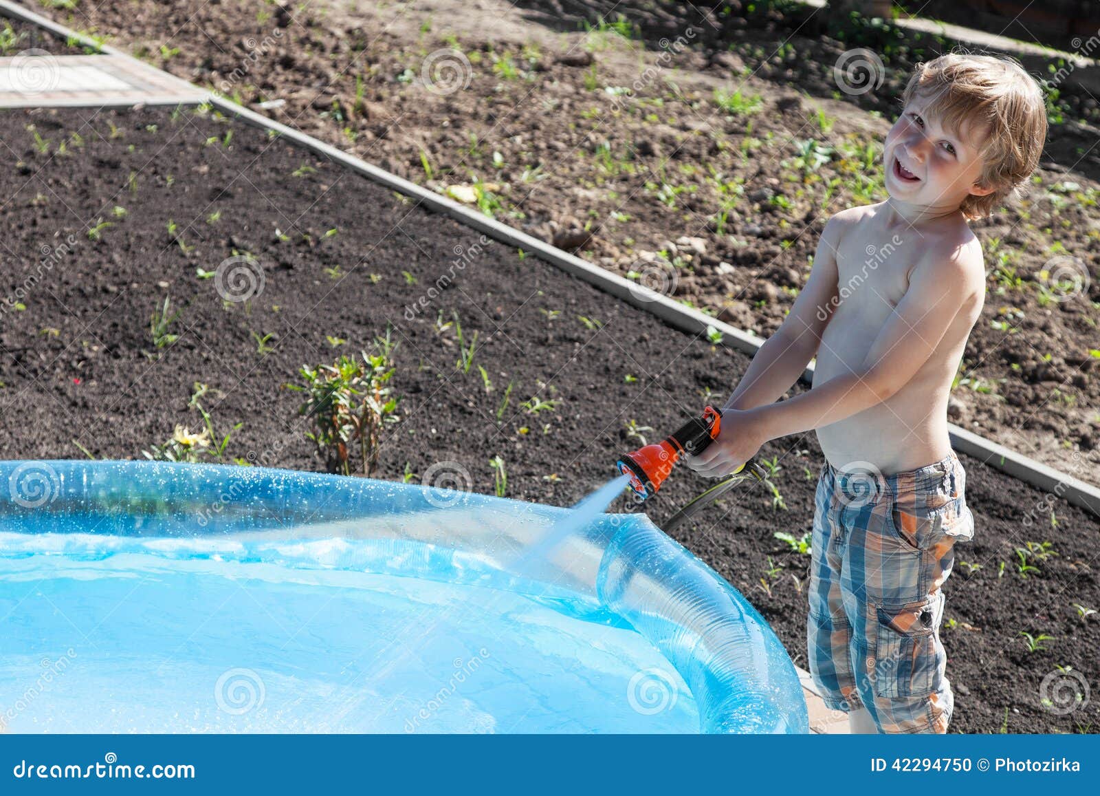 Boy fills up with water stock photo. Image of child, preschooler 42294750