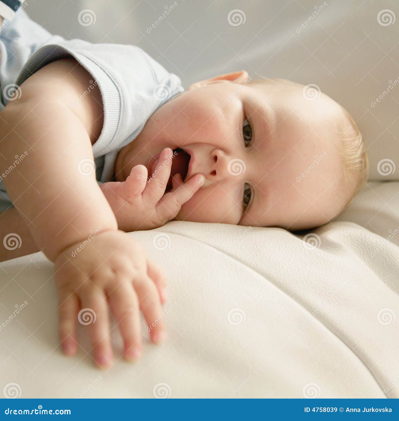 Curious Infant Baby Lying In Crib And Chewing His Finger 