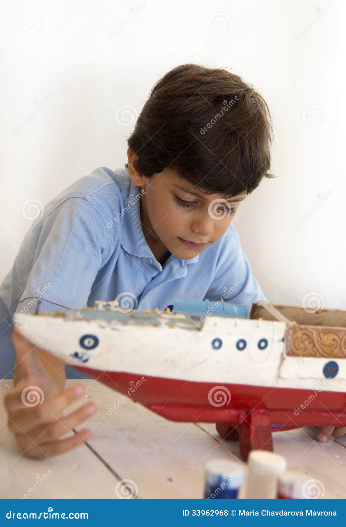 Boy fixing old wooden ship stock photo. Image of creative 33962968