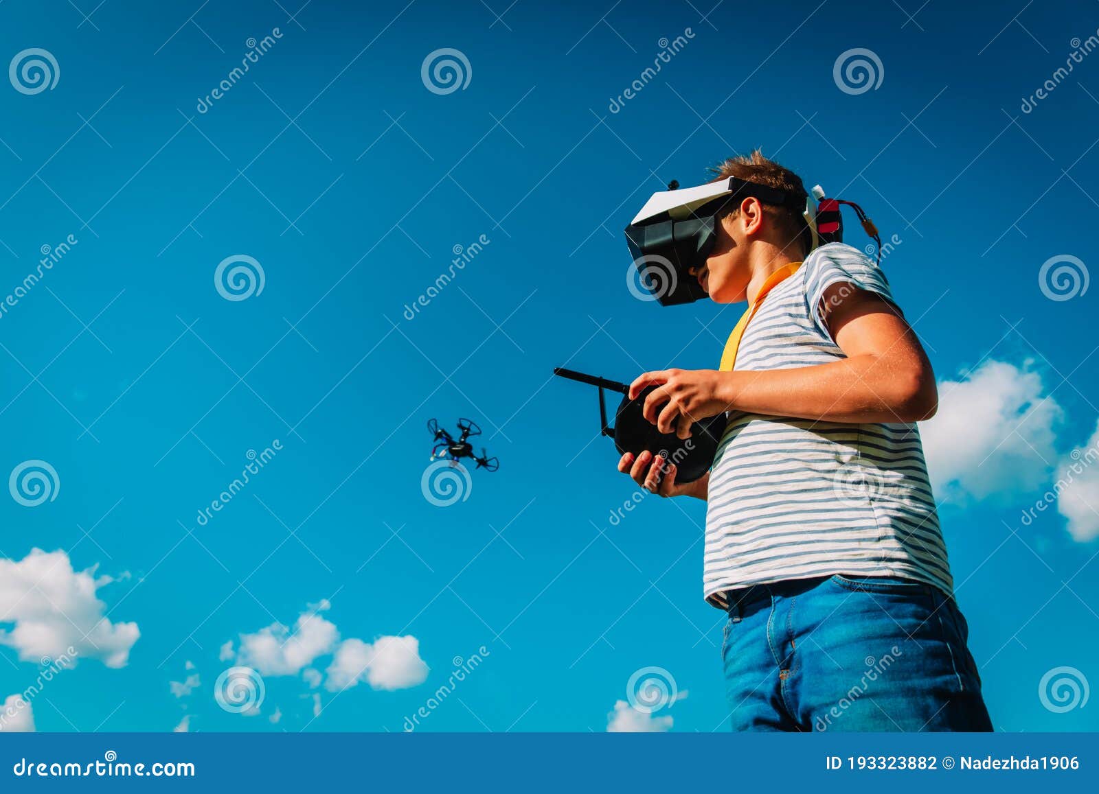 Boy Flying Drone in Virtual Reality Glasses in Nature Stock Photo
