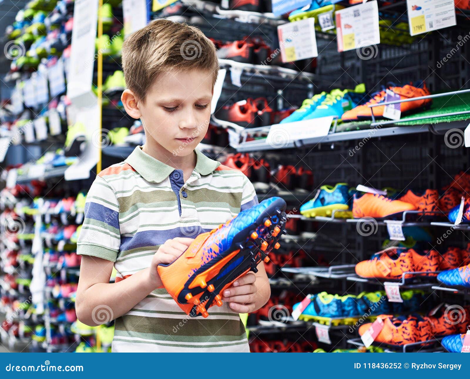 Boy With Football Boots In Sport Store 
