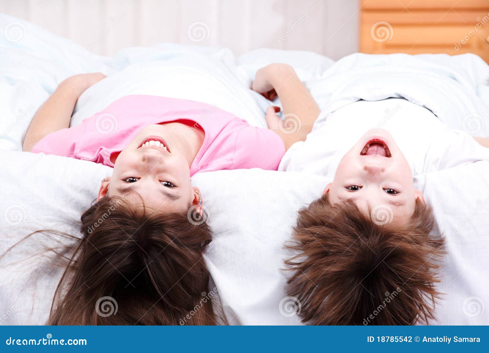 Boy and girl lying on bed stock photo. Image of brother 18785542