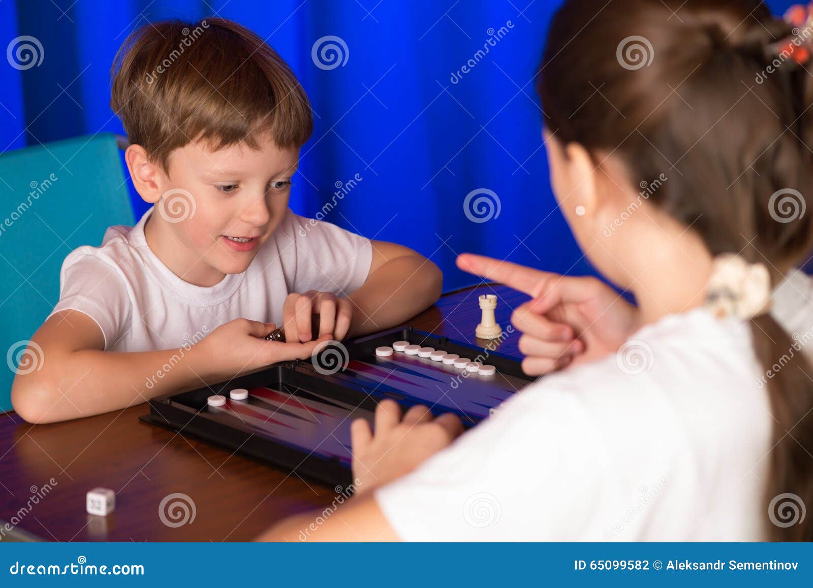 Boy and Girl Playing a Board Game Called Backgammon Stock Photo Image