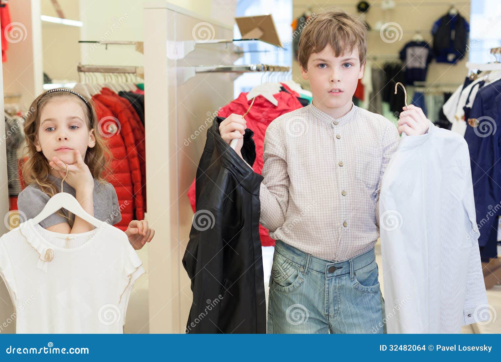 The Boy with the Girl Trying on Clothes Stock Photo - Image of children ...