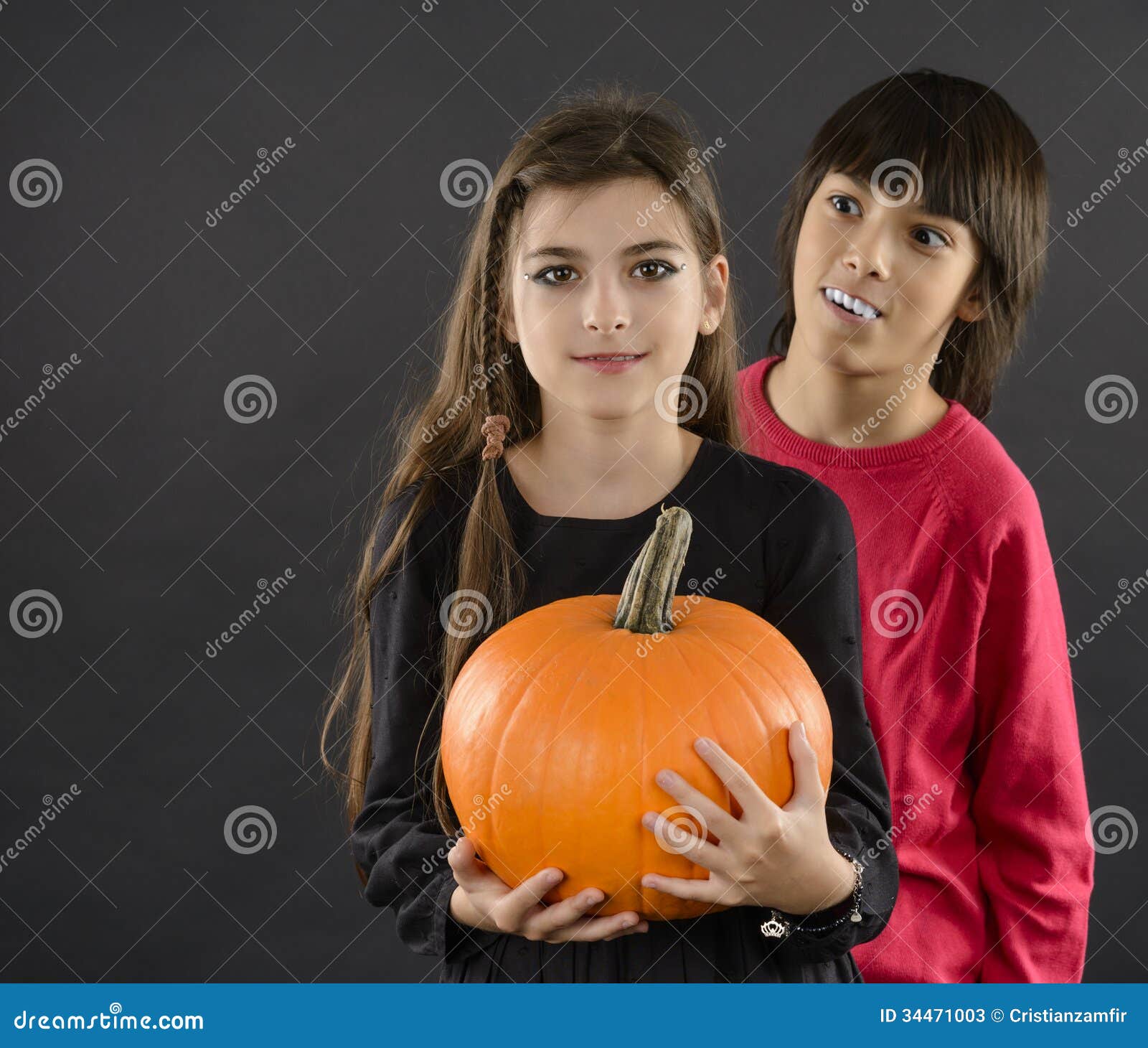 Boy And Girl Wearing Halloween Costume With Pumpkin On Black Ba ... Boy And Girl Wearing Halloween Costume With Pumpkin On Black Ba ...