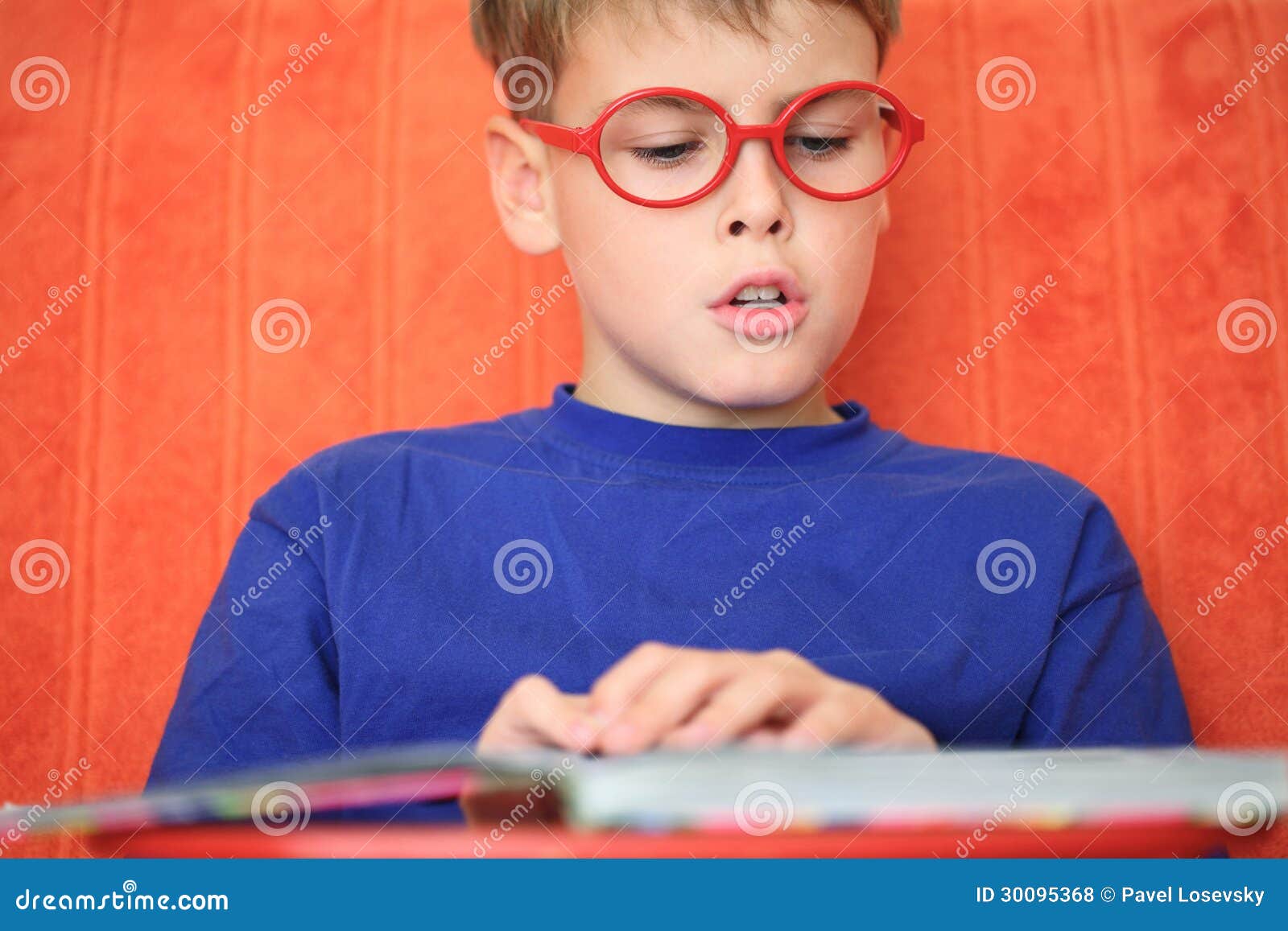 boy reading a book intently