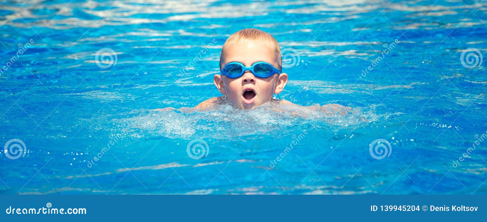 The Boy in Glasses for Swimming Swims in the Pool. Stock Photo Image