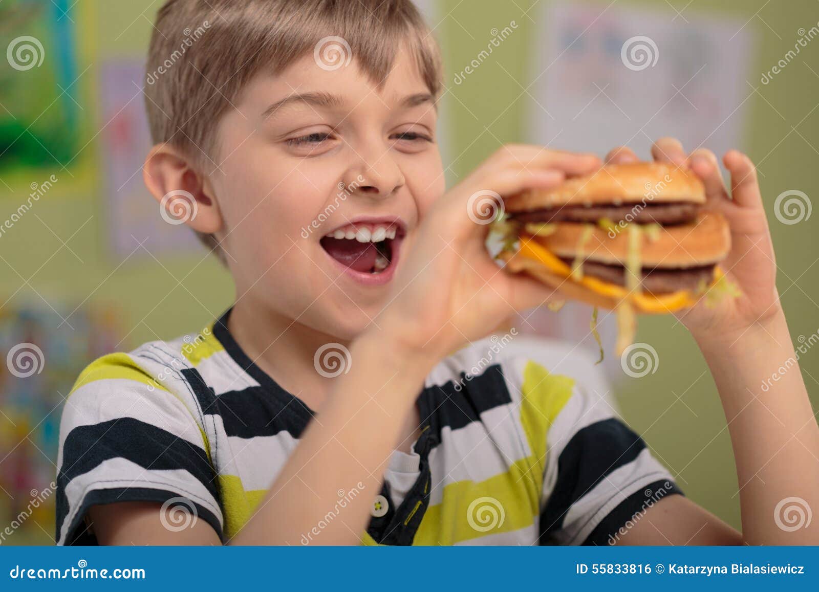 Boy and greasy burger stock photo. Image of bite, burger 55833816