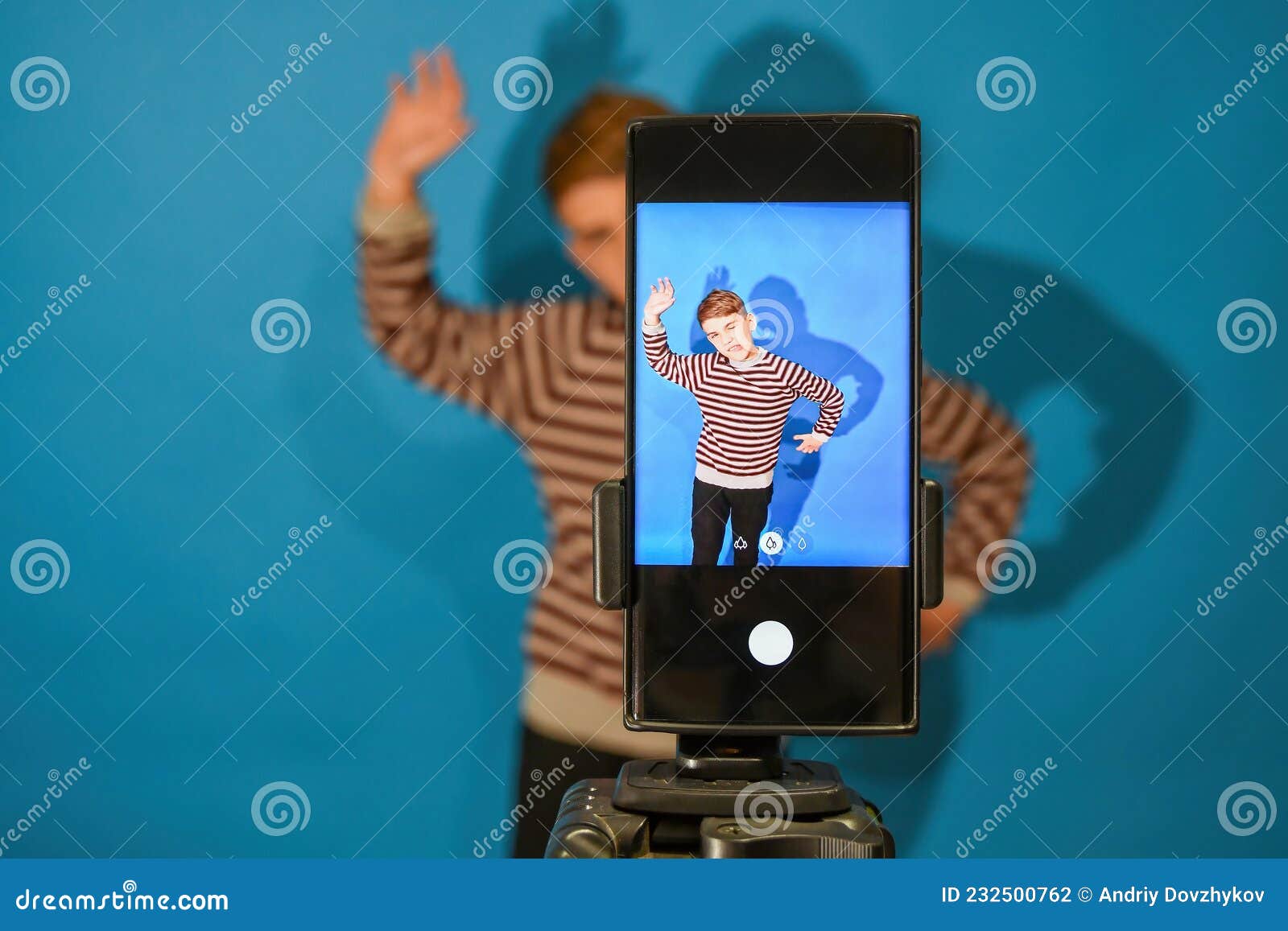 The Boy Grimaces and Poses on a Mobile Camera in the Studio To Download and  Watch Funny Videos Stock Photo - Image of media, communication: 232500762