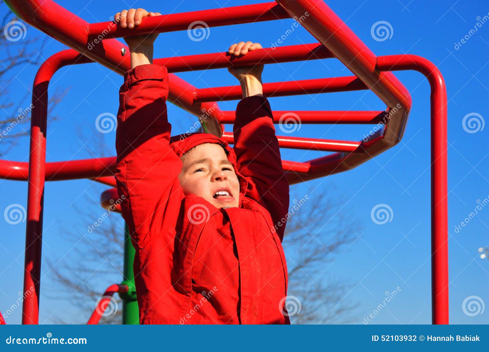 Boy Hanging on Monkey Bars stock photo. Image of healthy 52103932