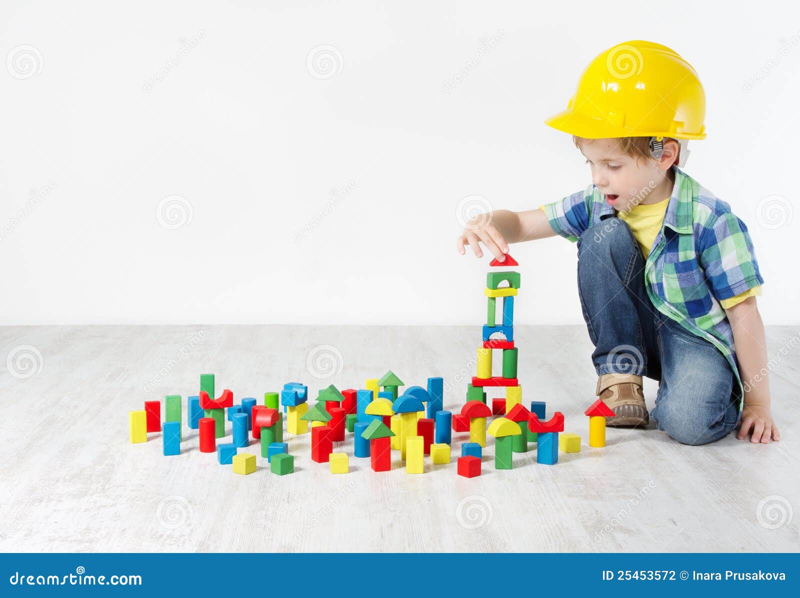 kids play room, child in hard hat playing building blocks toys