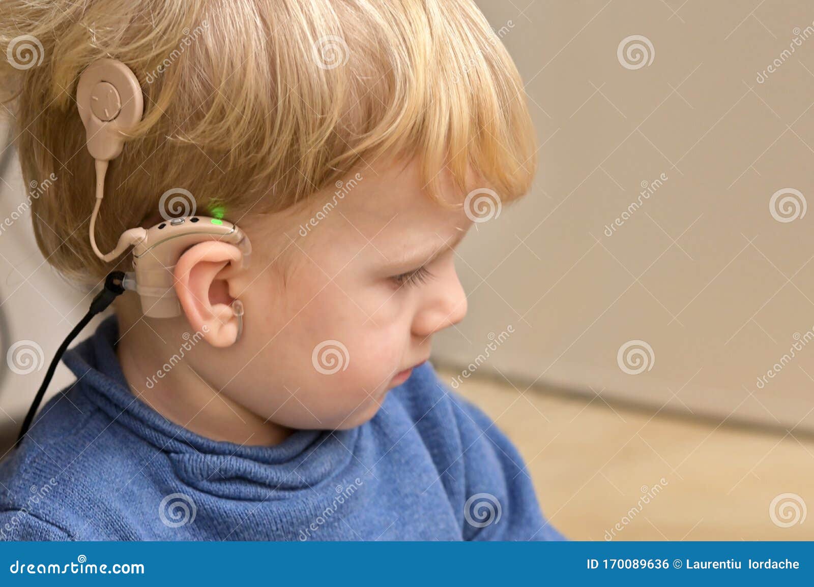 boy with a hearing aids and cochlear implants