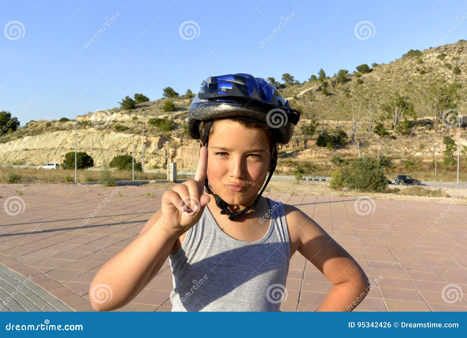 boy with helmet riding monowheel on promenade