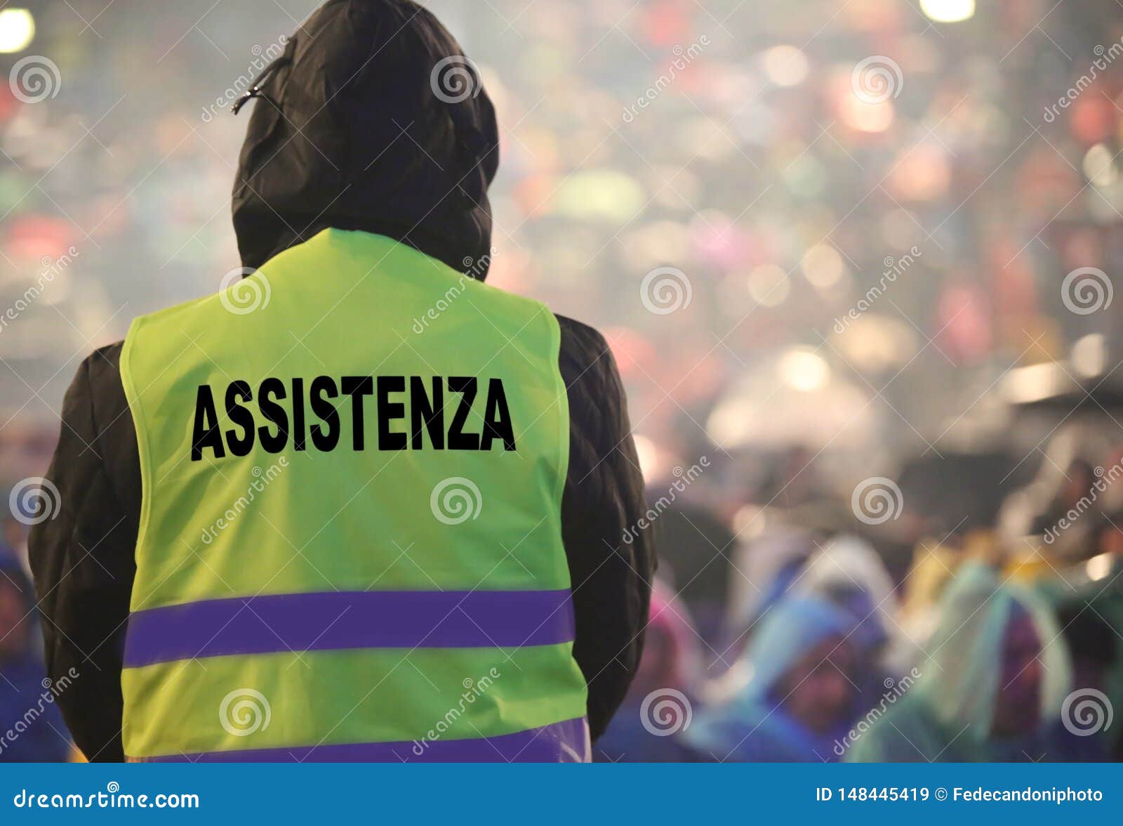 boy with high visibility jacket and the text that means assistan