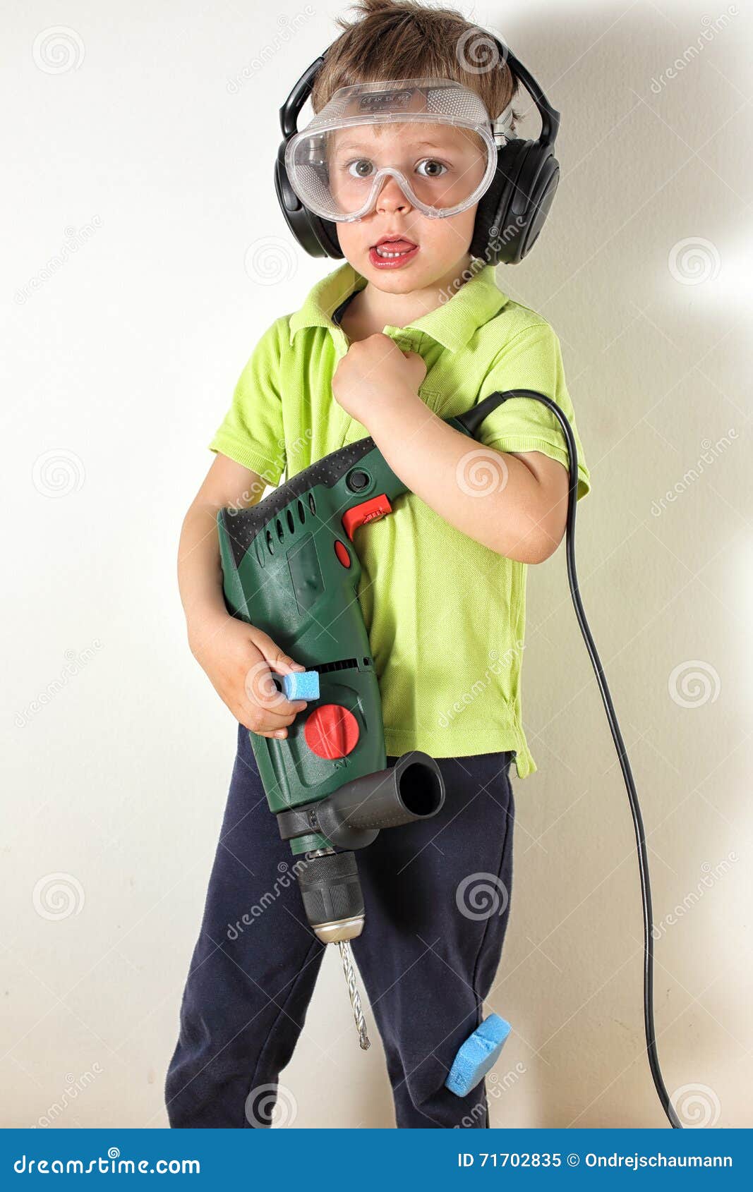 Boy holding drill upright stock image. Image of strong 71702835