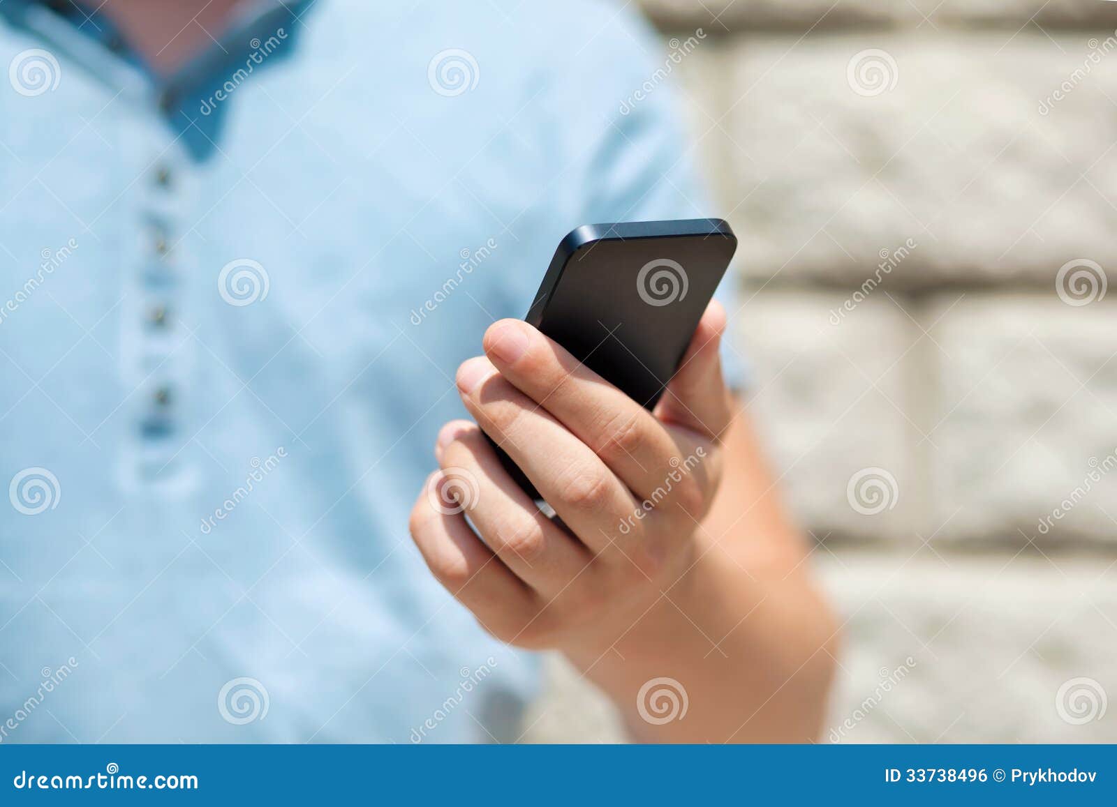 Boy Holding a Phone Against a Green Wall Stock Photo - Image of media ...