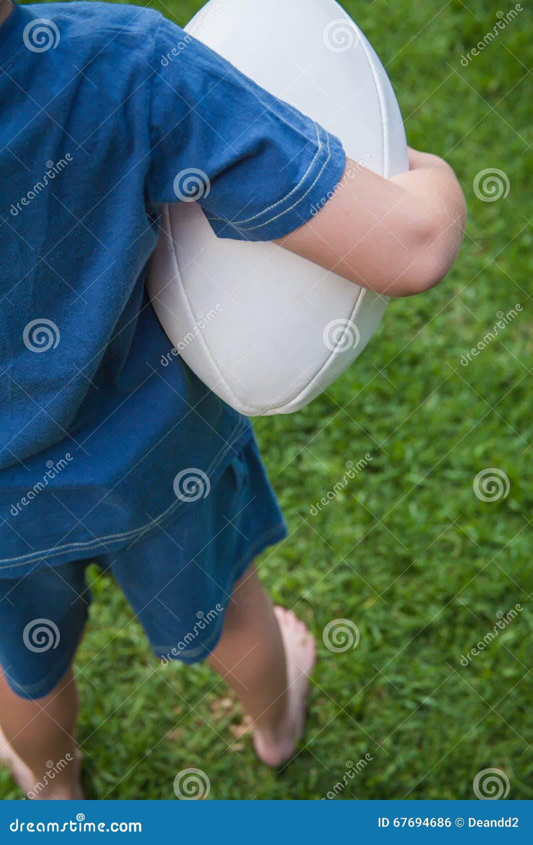 Boy holding Rugby Ball stock photo. Image of ball, activity 67694686