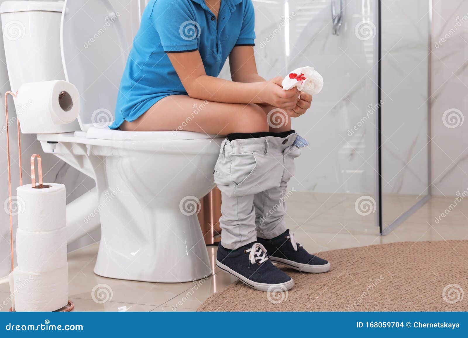 Boy Holding Toilet Paper With Blood Stain In Rest Room Hemorrhoid