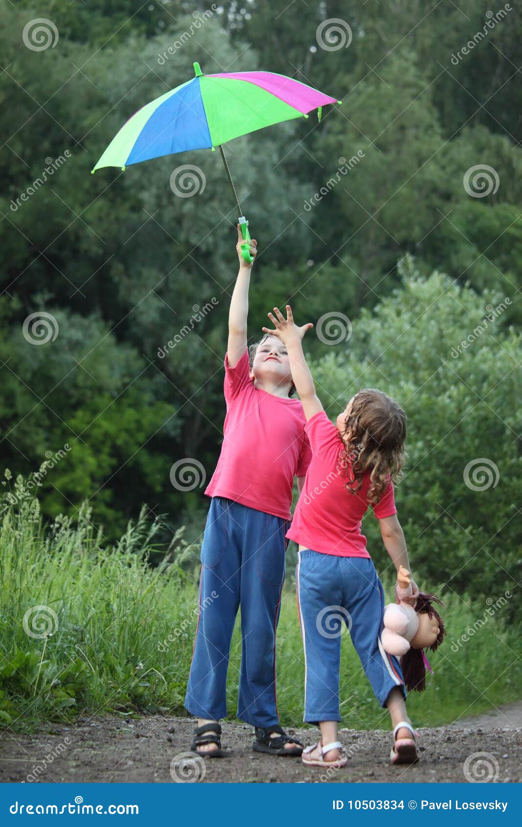 Boy Holds Umbrella Over Head, Girl Pulls To Stock Photo Image of