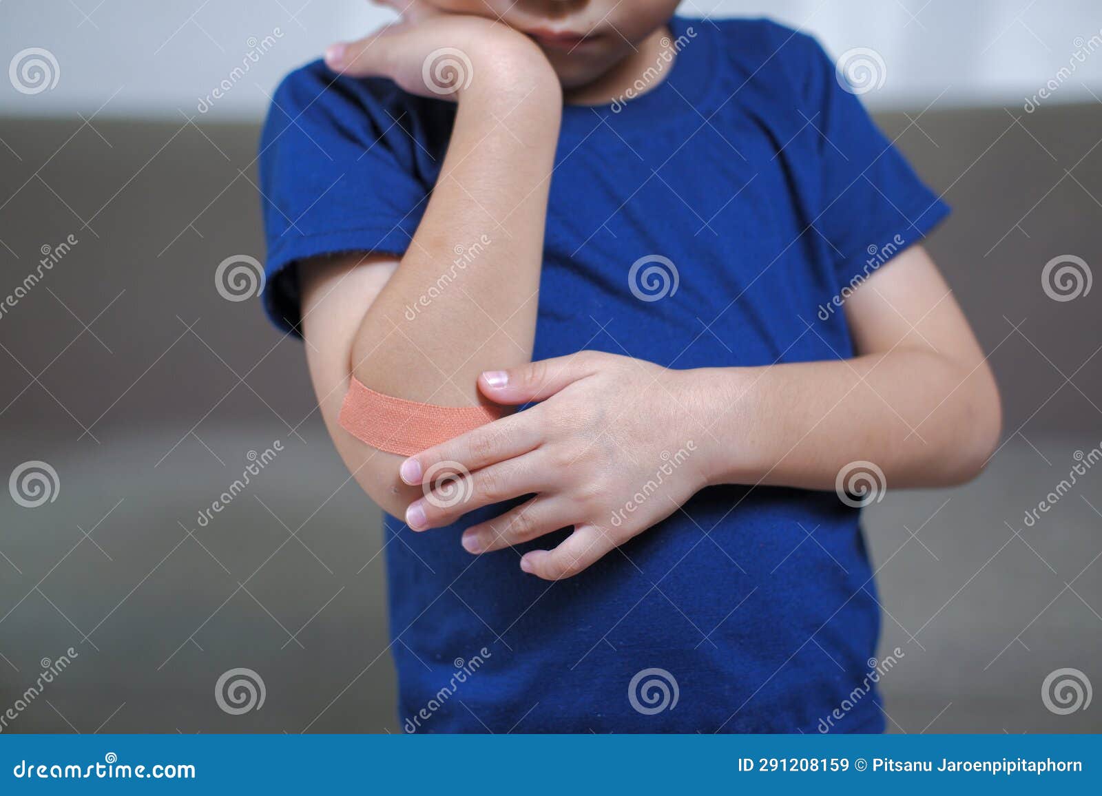 A Boy Hurts His Arm, Holding His Bandaged Arm Stock Image Image of