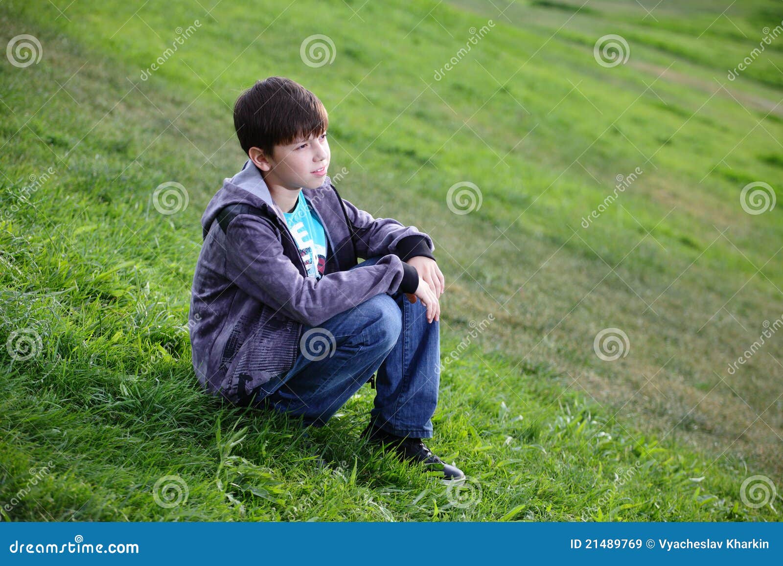 Teen Guy in Sunglasses is Sitting on the Grass in Nature in a Shirt and  Jeans Stock Image - Image of grass, handsome: 231383091