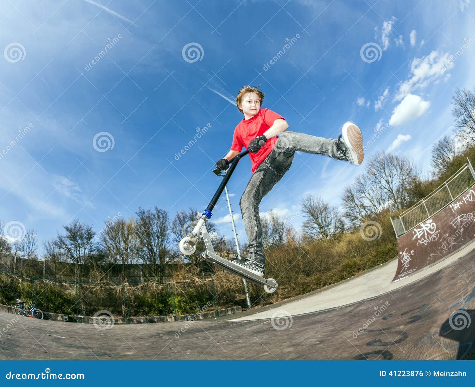 Boy jumping with a scooter stock photo. Image of airborne 41223876