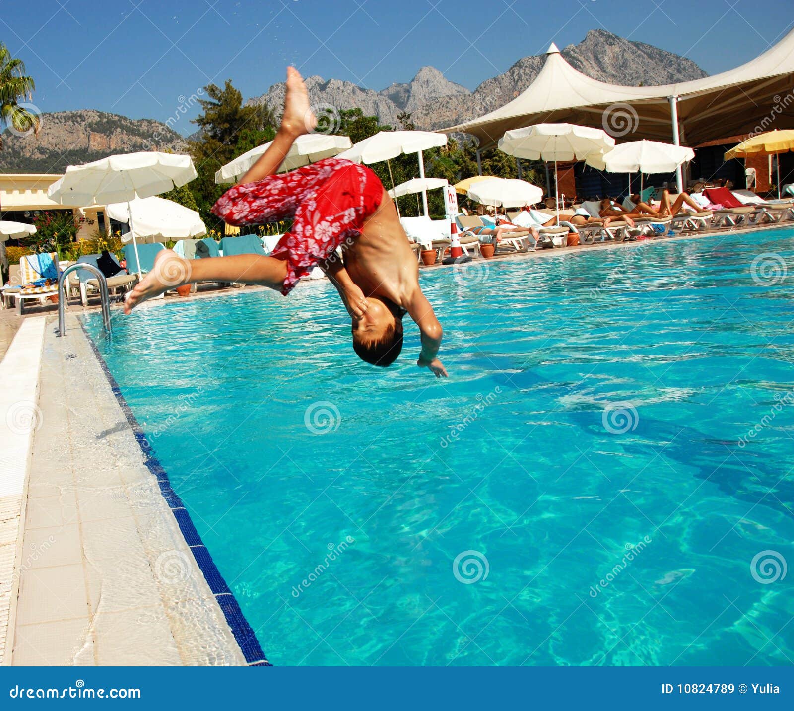 Beauty Woman Sitting On Edge Of Swimming Pool Stock Photos 