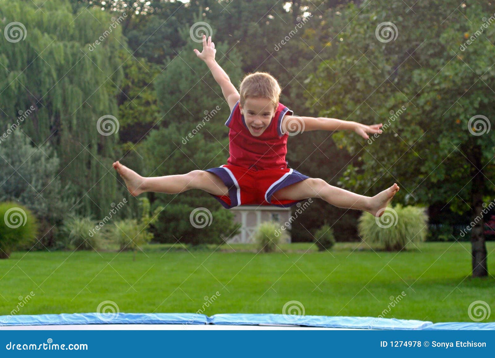 Boy Jumping on trampoline stock photo. Image of childhood 1274978
