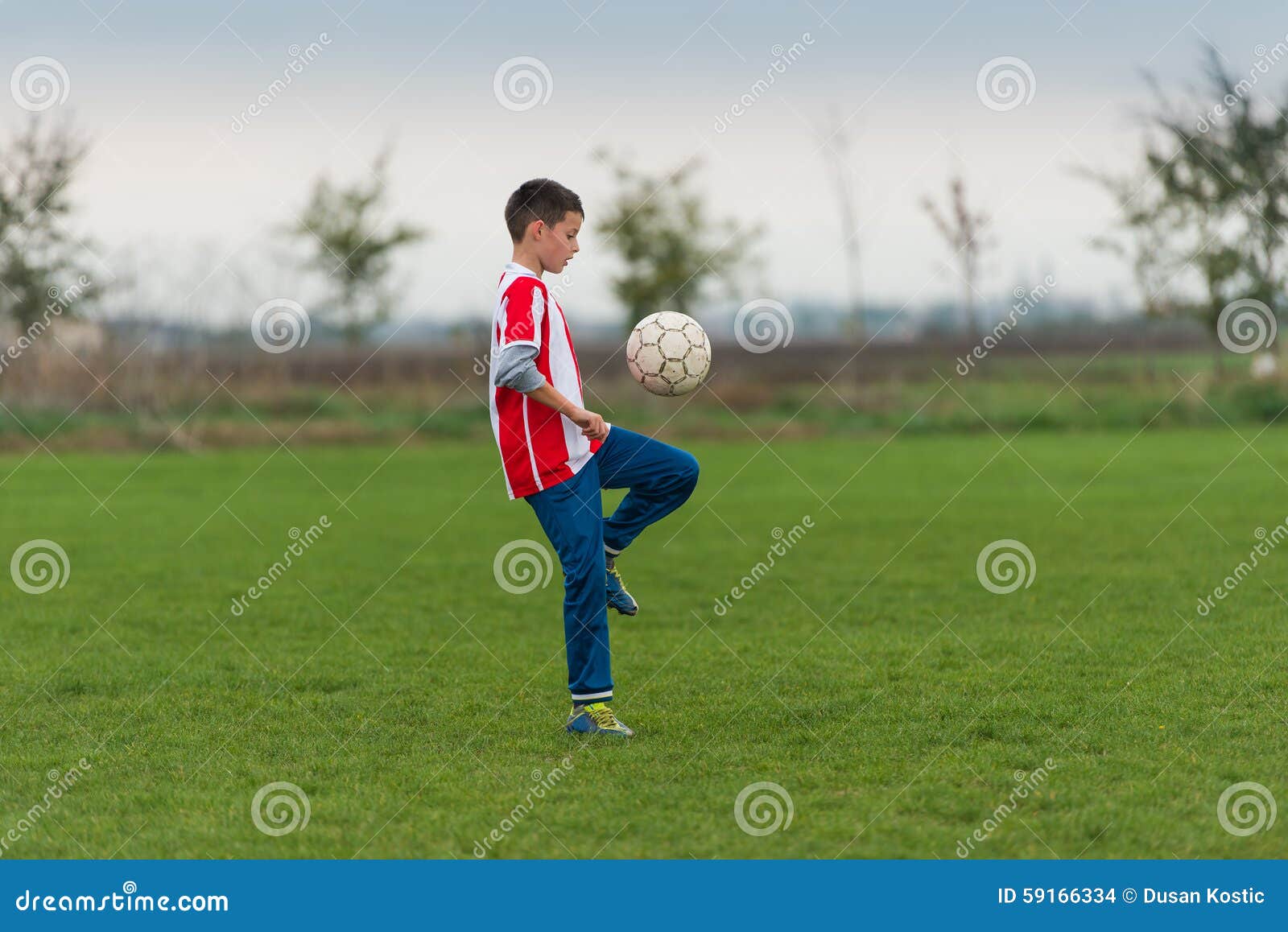 Boy kicking football stock photo. Image of grass, kick 59166334