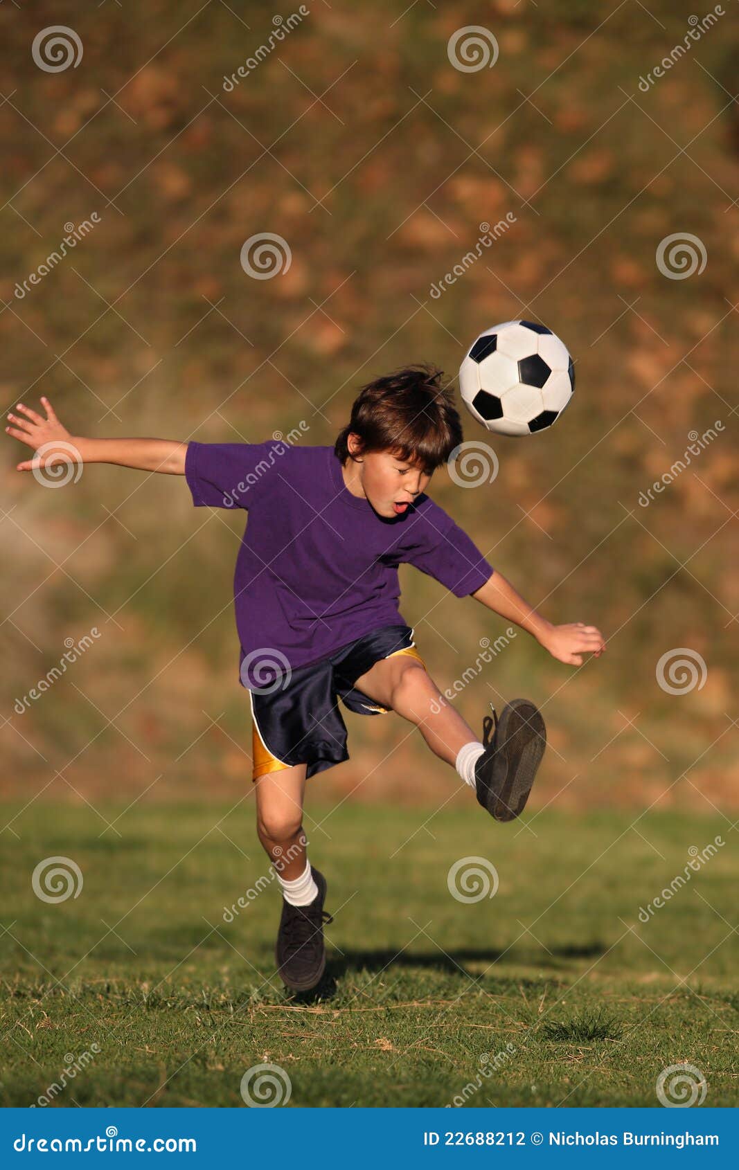 Boy Kicking Soccer Ball Stock Photography - Image: 22688212