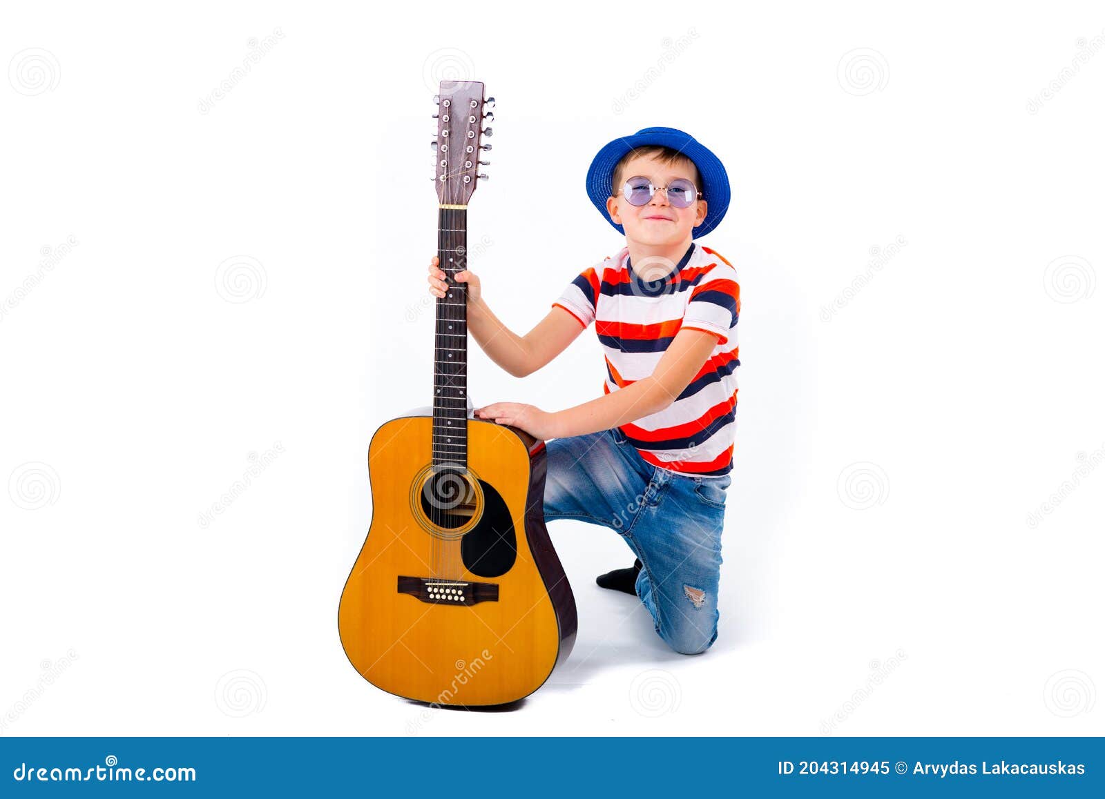 A Boy Kid Holding Guitar On A White Studio Background RoyaltyFree