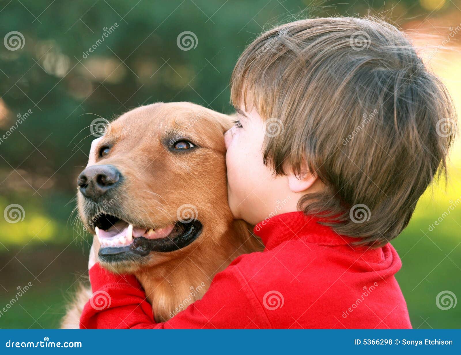 boy kissing dog
