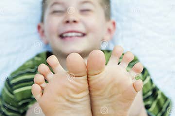 Boy laughing barefoot toes stock photo. Image of wiggling - 58174998