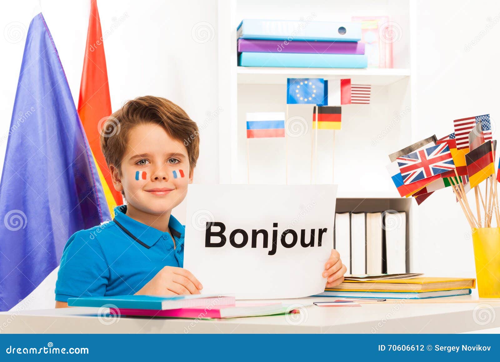 Boy Learning French Sitting At Desk In Classroom Stock Photo