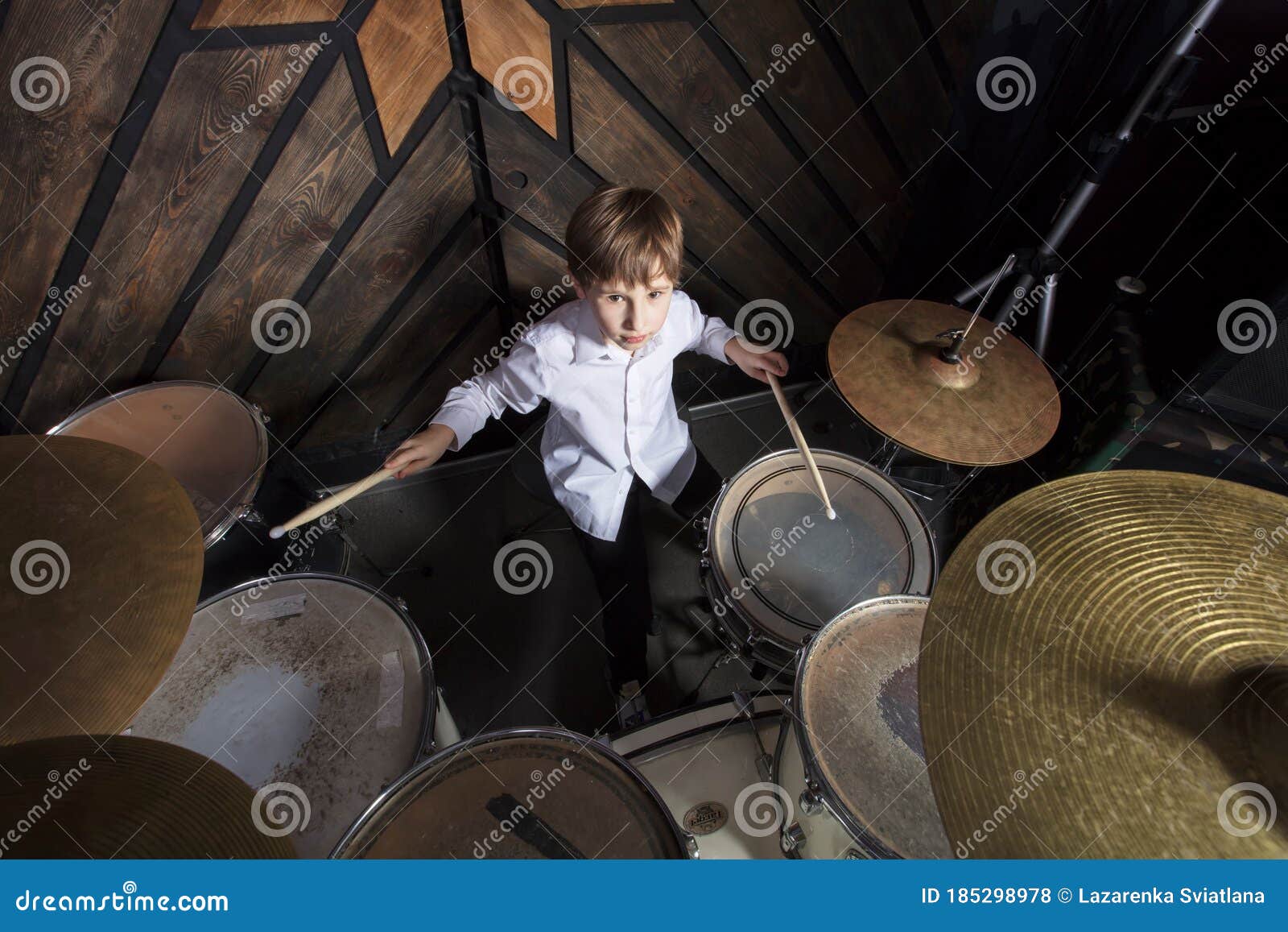 The Boy Learns To Play the Drums. Stock Photo Image of happy, music