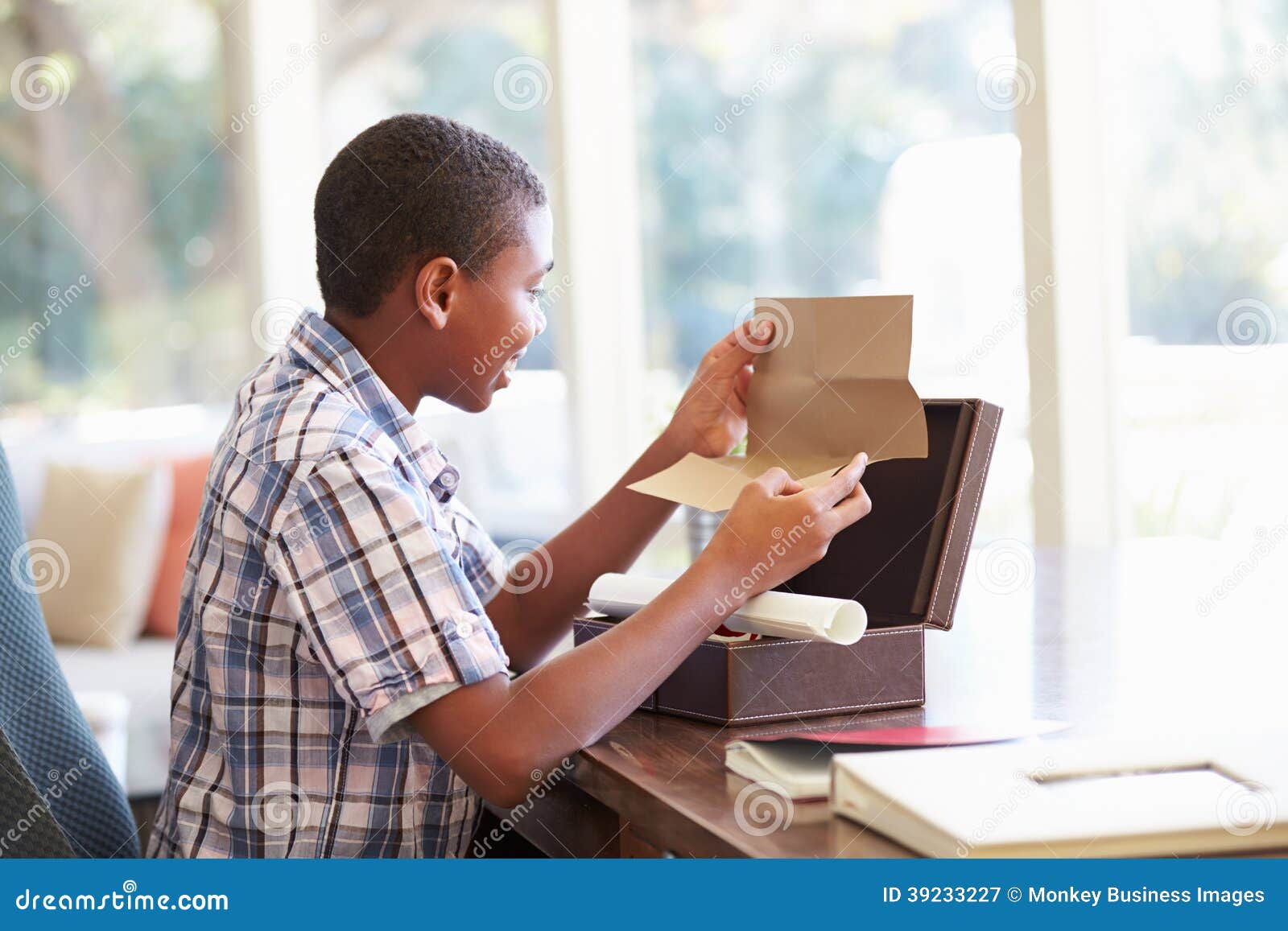 boy looking at letter in keepsake box on desk