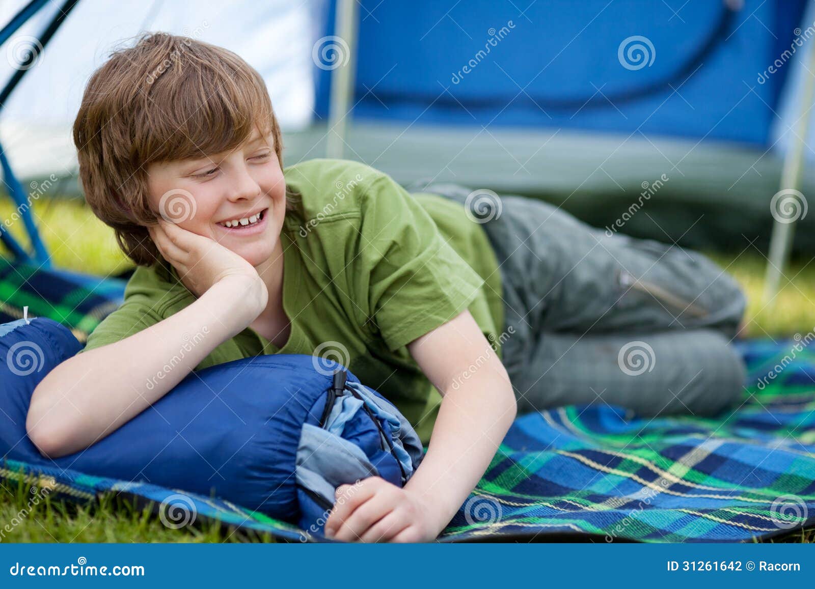 Boy Lying on Sleeping Bag stock photo. Image of preadolescent 31261642