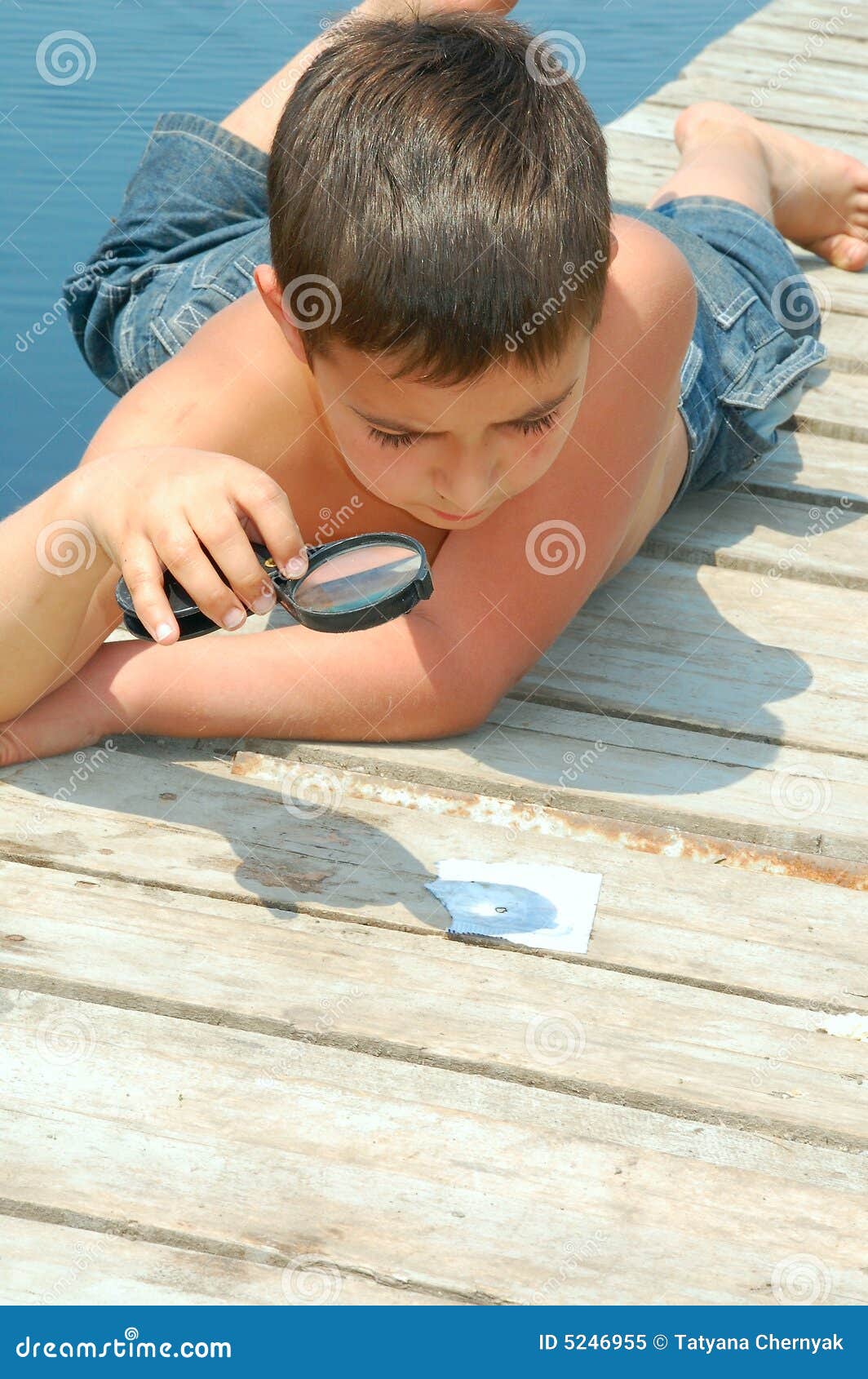 Boy with a magnifier stock image. Image of pier, explorer 5246955