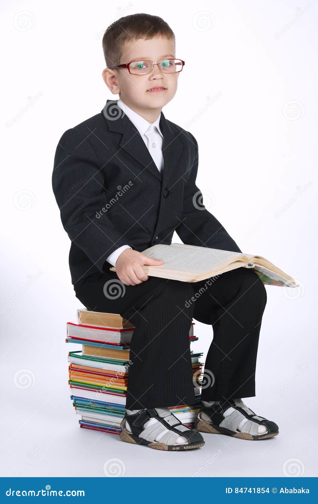Boy Makes Homework Sitting On Stack Of Books Stock Photo ...