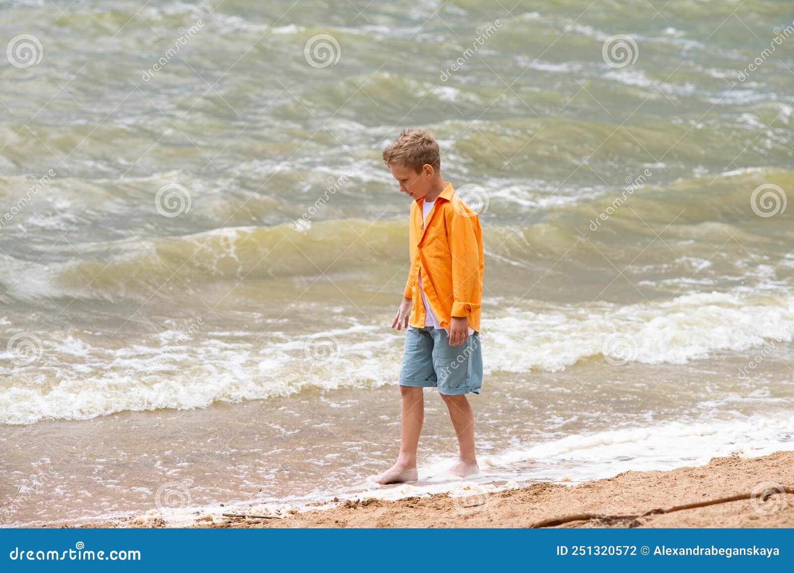 A Boy in an Orange Shirt on the Seashore Stock Photo Image of