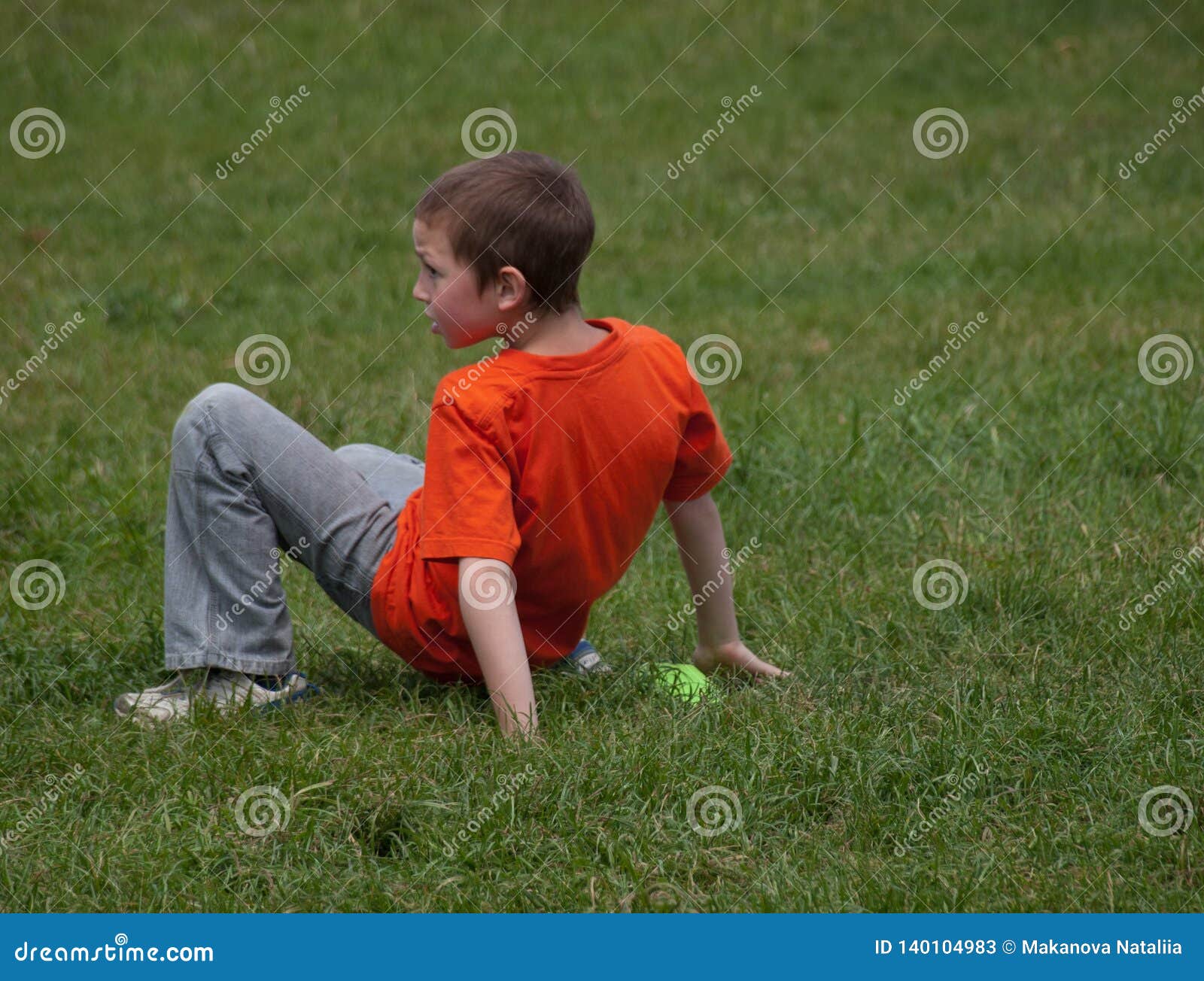 Boy in Orange T-shirt Playing in the Grass Stock Image - Image of ...