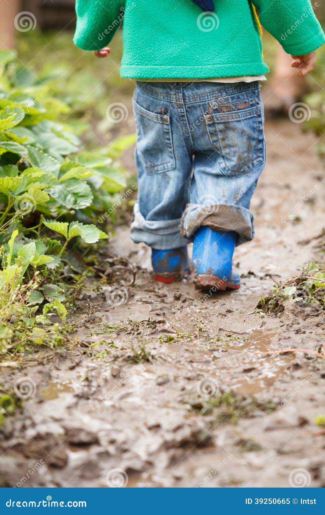 boy palaying in mud