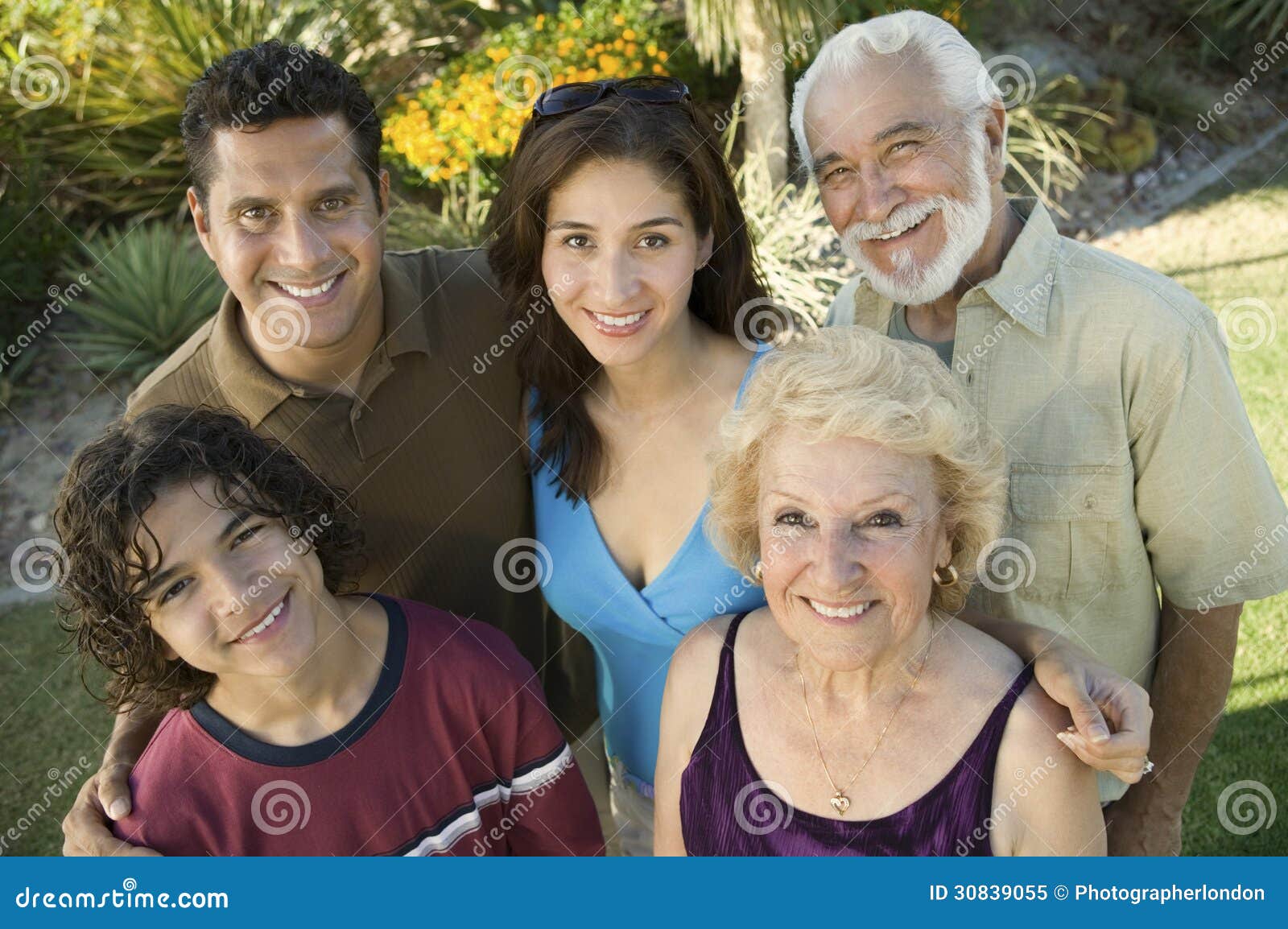 boy (13-15) with parents and grandparents outside elevated view portrait.